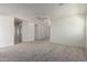 Spacious living area with neutral carpet, ceiling fan, and open layout, ideal for entertaining and relaxation at 44792 W Paitilla Ln, Maricopa, AZ 85139