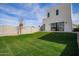Lush backyard featuring well-maintained green grass, a modern home design, and block fence at 4514 N 8Th Pl, Phoenix, AZ 85014