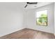 Well-lit bedroom with hardwood floors and window overlooking greenery at 4514 N 8Th Pl, Phoenix, AZ 85014