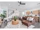 Open-concept living room showcasing a modern leather sofa, stylish chairs, and a decorative ceiling fan at 4514 N 8Th Pl, Phoenix, AZ 85014