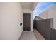 Private side entrance features a sleek black door, set against a modern white exterior and gravel pathway at 4514 N 8Th Pl, Phoenix, AZ 85014