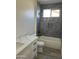 Bathroom featuring stylish marble tile, white cabinets, and a shower with a niche at 5320 E Pony Track Ln, San Tan Valley, AZ 85140