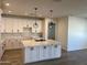 Kitchen with a large island, modern appliances, and stylish pendant lighting at 5320 E Pony Track Ln, San Tan Valley, AZ 85140