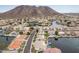 Extensive aerial view featuring a neighborhood on the water with a mountain backdrop at 5323 W Rose Garden Ln, Glendale, AZ 85308