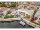 Aerial view of property with pool, dock, and waterfront views at 5323 W Rose Garden Ln, Glendale, AZ 85308