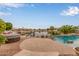 Backyard area with pool, hot tub and water feature on community lake at 5323 W Rose Garden Ln, Glendale, AZ 85308