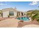 Beautiful backyard with pool, rock features and lush desert landscaping at 5323 W Rose Garden Ln, Glendale, AZ 85308