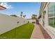 Backyard with a putting green and a view through open doors at 5323 W Rose Garden Ln, Glendale, AZ 85308