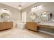 Spa bathroom with standalone tub, double vanity and modern light fixtures at 5323 W Rose Garden Ln, Glendale, AZ 85308