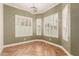 Bright bay window seating area with wooden floors, designer ceiling light and plantation shutters at 5323 W Rose Garden Ln, Glendale, AZ 85308