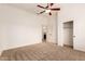 Bedroom featuring neutral carpet, a ceiling fan and a large closet at 5323 W Rose Garden Ln, Glendale, AZ 85308