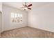 Bedroom with neutral carpet, a ceiling fan and plantation shutters at 5323 W Rose Garden Ln, Glendale, AZ 85308