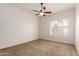 Bedroom with neutral carpet, a ceiling fan and plantation shutters at 5323 W Rose Garden Ln, Glendale, AZ 85308