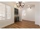 Open dining area with plantation shutters and a modern chandelier at 5323 W Rose Garden Ln, Glendale, AZ 85308