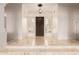 Bright foyer featuring decorative light fixture, and a large front door with side windows at 5323 W Rose Garden Ln, Glendale, AZ 85308