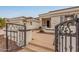 Close up view of a home's entrance with a decorative metal gate leading up to the front door at 5323 W Rose Garden Ln, Glendale, AZ 85308