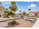 Home featuring a gated entrance leading to a lush courtyard with potted plants and charming desert landscaping at 5323 W Rose Garden Ln, Glendale, AZ 85308