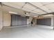 Spacious garage with ample storage cabinets, lighting and epoxy flooring at 5323 W Rose Garden Ln, Glendale, AZ 85308