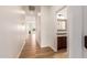 Bright hallway with wood floors leading to an open living space at 5323 W Rose Garden Ln, Glendale, AZ 85308