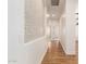 Hallway with detailed accent wall and wood-style floors at 5323 W Rose Garden Ln, Glendale, AZ 85308