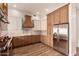 Bright kitchen includes custom wood cabinetry, stainless steel appliances and tile backsplash at 5323 W Rose Garden Ln, Glendale, AZ 85308