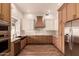 Modern kitchen featuring stainless steel appliances, custom cabinets, and a decorative tile backsplash at 5323 W Rose Garden Ln, Glendale, AZ 85308