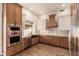 Well-lit kitchen showcases stainless steel appliances and ample counter space at 5323 W Rose Garden Ln, Glendale, AZ 85308