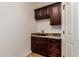 Functional laundry room with custom cabinetry and granite countertops at 5323 W Rose Garden Ln, Glendale, AZ 85308