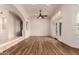 Bright living room features wood floors, a ceiling fan, shutters, and French doors at 5323 W Rose Garden Ln, Glendale, AZ 85308