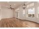 Bright living room boasts wood floors, ceiling fan, chandelier, and a view of the canal at 5323 W Rose Garden Ln, Glendale, AZ 85308