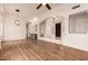 Spacious living room with wood floors, columns, archways, and a wet bar at 5323 W Rose Garden Ln, Glendale, AZ 85308