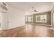 Expansive living room with herringbone-patterned wood floors and large windows with shutters at 5323 W Rose Garden Ln, Glendale, AZ 85308