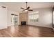 Spacious living room features fireplace, ceiling fan, wood floors, and sliding door access at 5323 W Rose Garden Ln, Glendale, AZ 85308
