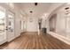 Bright living room features wood floors, shutters, and wet bar with view to backyard at 5323 W Rose Garden Ln, Glendale, AZ 85308