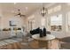 Bright living room with large windows, modern furnishings, and views of the waterfront at 5323 W Rose Garden Ln, Glendale, AZ 85308