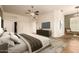 Spacious primary bedroom with a ceiling fan, patterned rug, and a large window at 5323 W Rose Garden Ln, Glendale, AZ 85308