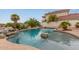Stunning pool with rock waterfall features and serene views of the community lake at 5323 W Rose Garden Ln, Glendale, AZ 85308