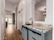 Hallway wet bar boasts granite countertop, under cabinet storage, and stainless steel faucet at 5323 W Rose Garden Ln, Glendale, AZ 85308