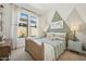 Stylish bedroom features a wooden bed frame, patterned wallpaper, and a large window with a garden view at 536 E Aurora Dr, San Tan Valley, AZ 85140