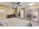 Relaxing main bedroom with a comfortable bed, sliding glass doors, and a ceiling fan for added comfort at 6138 E Nance St, Mesa, AZ 85215