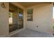 Backyard patio with a sliding glass door, a small window, and a concrete floor at 7318 W Sophie Ln, Laveen, AZ 85339