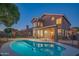 Fenced backyard with swimming pool, play structure, and covered patio at 7415 W Via De Luna Dr, Glendale, AZ 85310