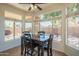 Bright dining area with a view of the backyard pool, surrounded by windows providing plenty of natural light at 7415 W Via De Luna Dr, Glendale, AZ 85310