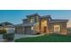 Beautiful two-story home featuring a well-manicured lawn and a three-car garage at 7415 W Via De Luna Dr, Glendale, AZ 85310