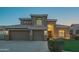 Beautiful two-story home featuring a well-manicured lawn and a three-car garage at 7415 W Via De Luna Dr, Glendale, AZ 85310