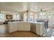 Kitchen featuring stainless steel appliances, white cabinets and countertops, and a view of the living area at 7415 W Via De Luna Dr, Glendale, AZ 85310