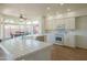 Bright kitchen featuring white cabinets, stainless steel appliances and a view of the backyard and dining area at 7415 W Via De Luna Dr, Glendale, AZ 85310