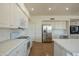 Kitchen featuring white cabinets, stainless steel appliances, and white tiled countertops at 7415 W Via De Luna Dr, Glendale, AZ 85310