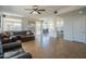 Open floor plan living room featuring a ceiling fan, a brown sofa and view of the outdoor patio and kitchen at 7415 W Via De Luna Dr, Glendale, AZ 85310