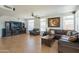 Spacious living room with tile flooring, fireplace, and comfortable leather furniture at 7415 W Via De Luna Dr, Glendale, AZ 85310